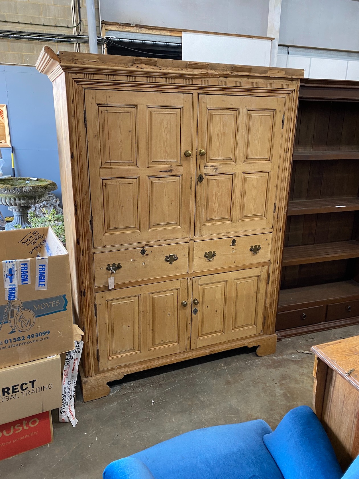 An early 19th century pine household cupboard, width 150cm, depth 65cm, height 196cm (cornice in need of repair / piece present).